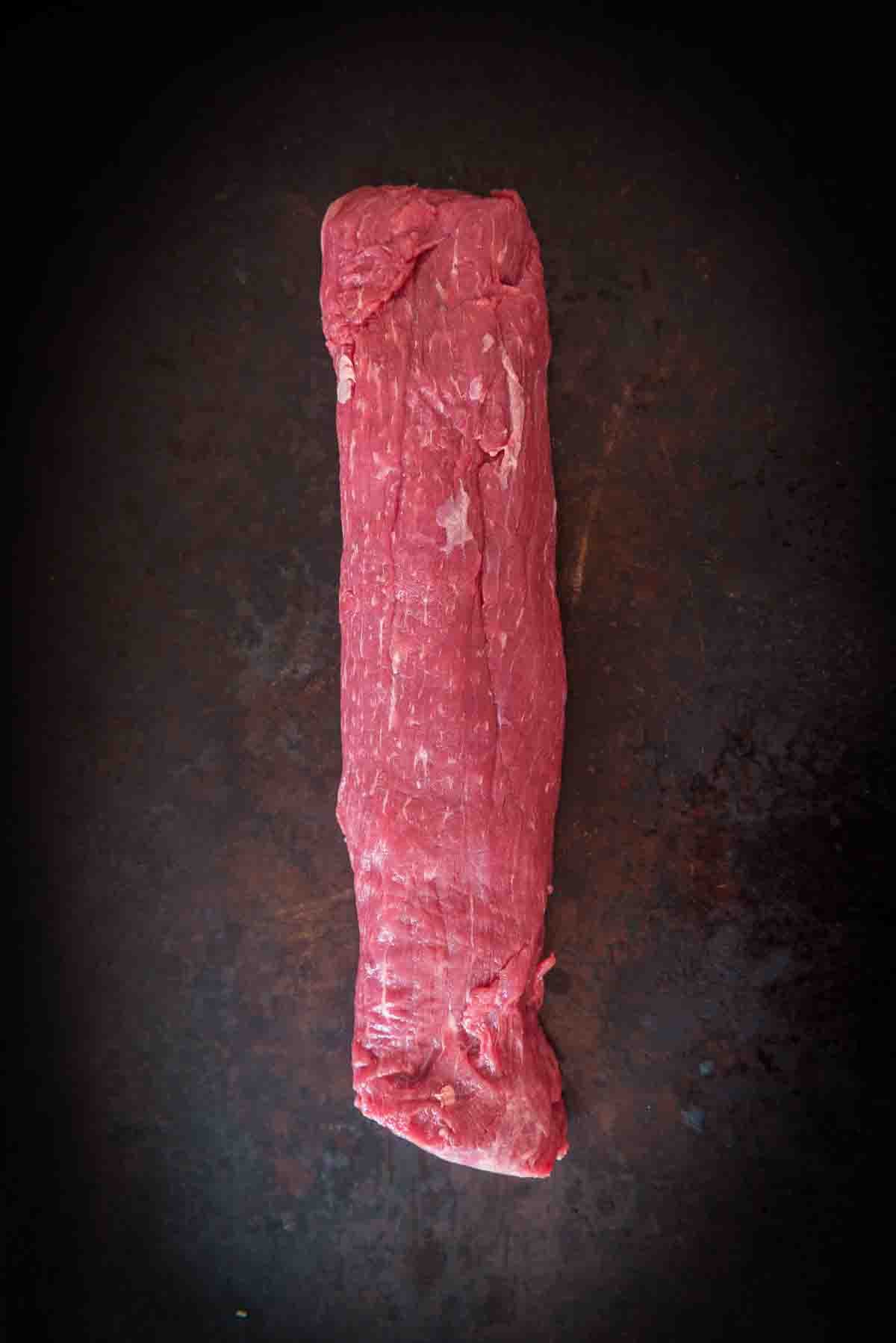 Raw Sierra steak on black board to show minimal marveling and fine visual grain. 