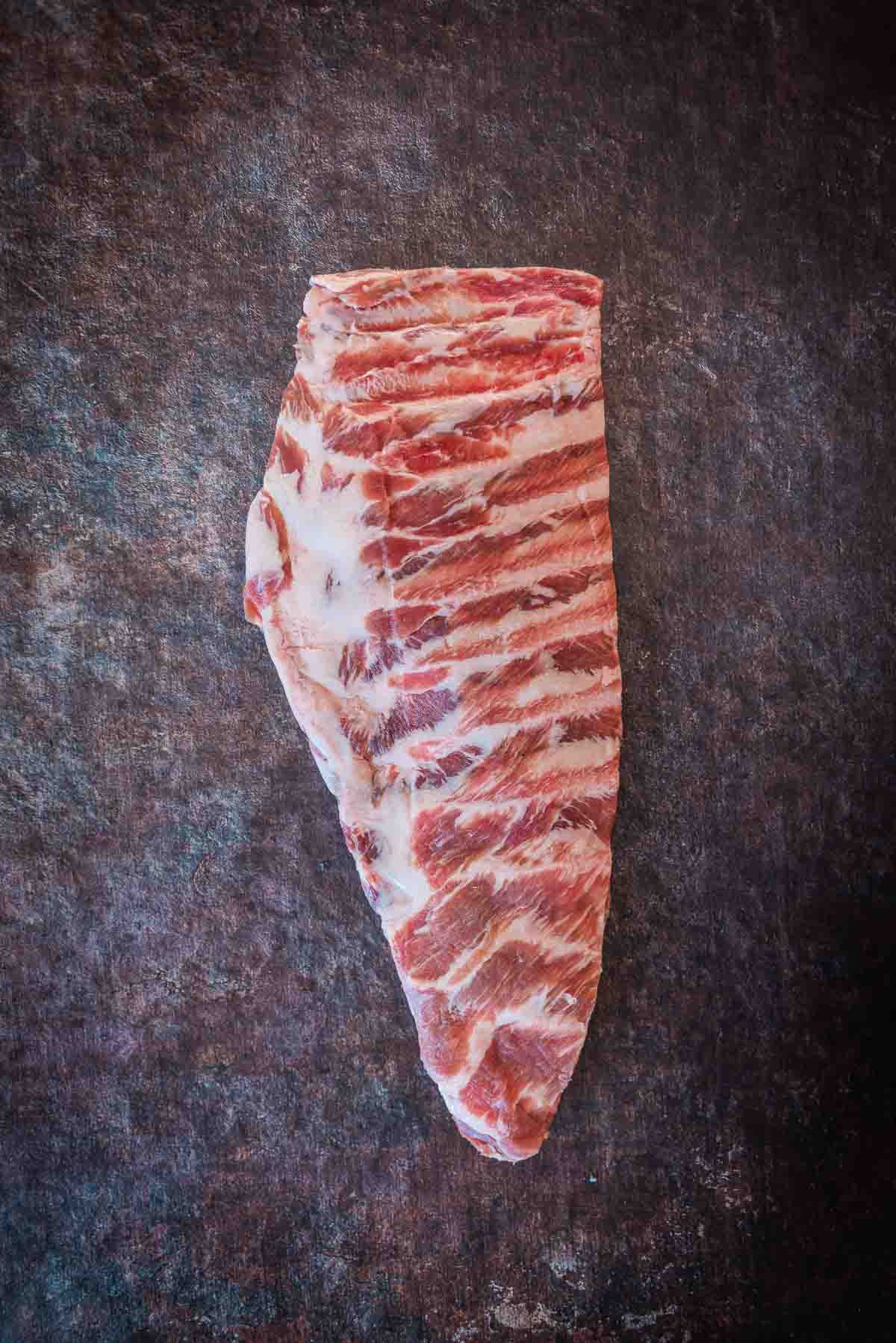 Whole slab of pork spareribs, untrimmed.