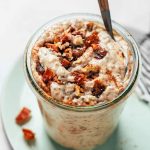 Creamy overnight oats mixed with chia seeds and nut butter in a glass jar.