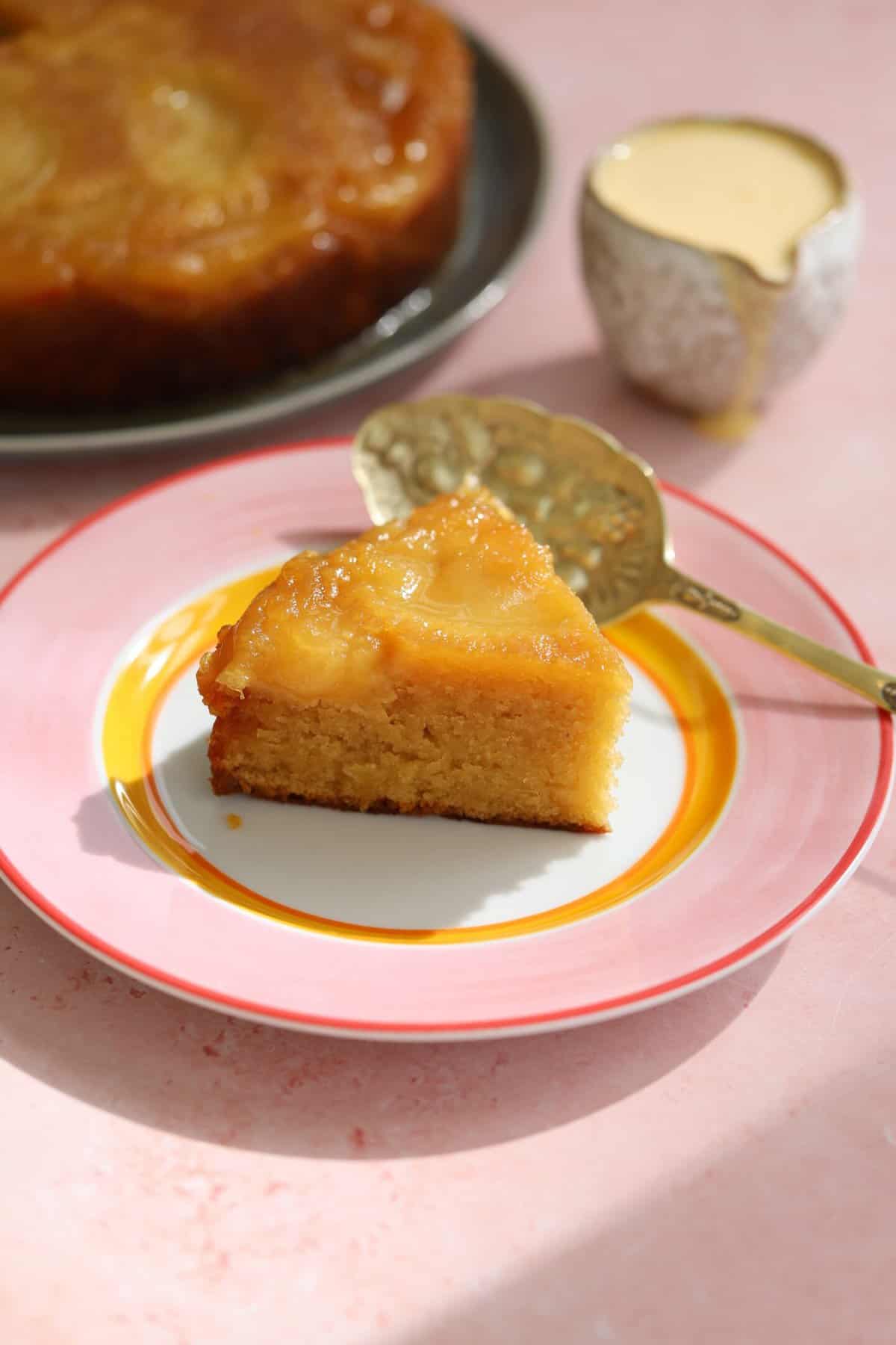 A slice of apple upside down cake on a plate.