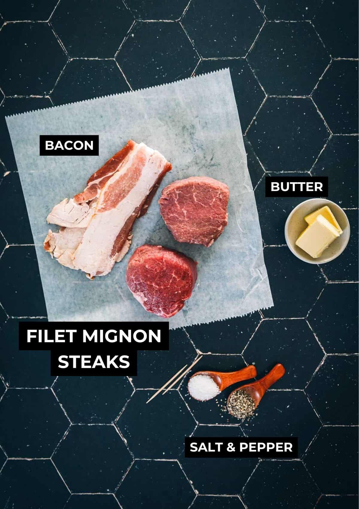 Ingredients for these bacon-wrapped filets on a black board.