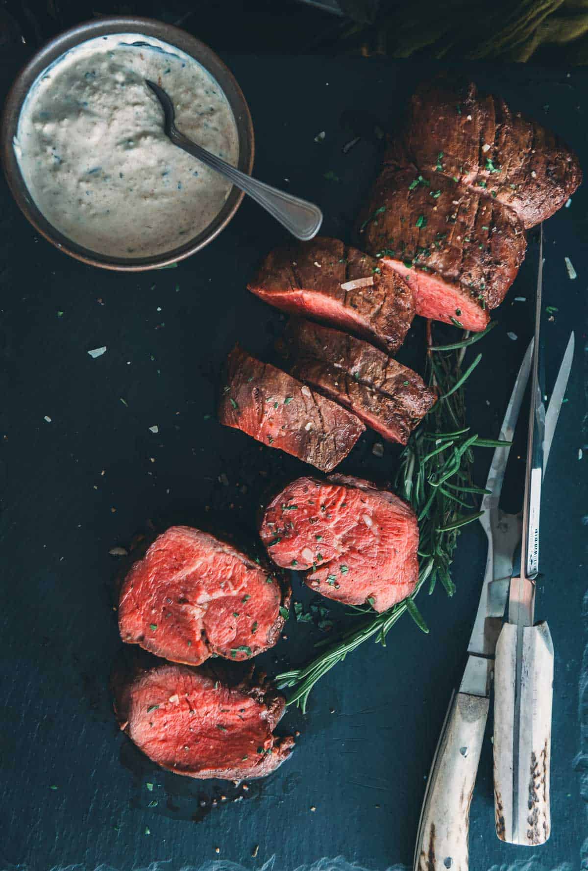 Beautiful medium rare slices of beef tenderloin to show the cook on the inside and crust on the outside.