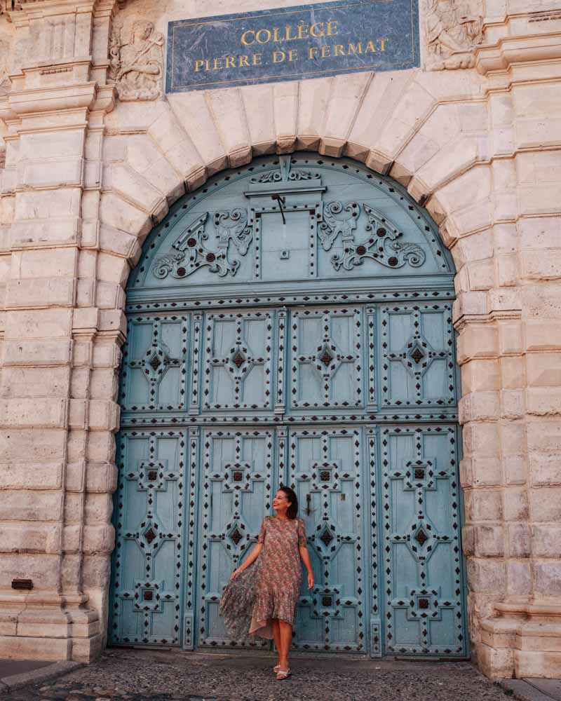 blue door in toulouse with female standing in front