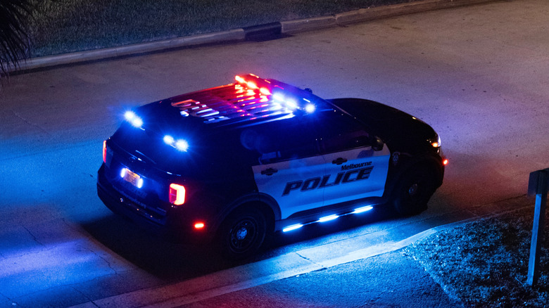 A police SUV at night with all lights on.