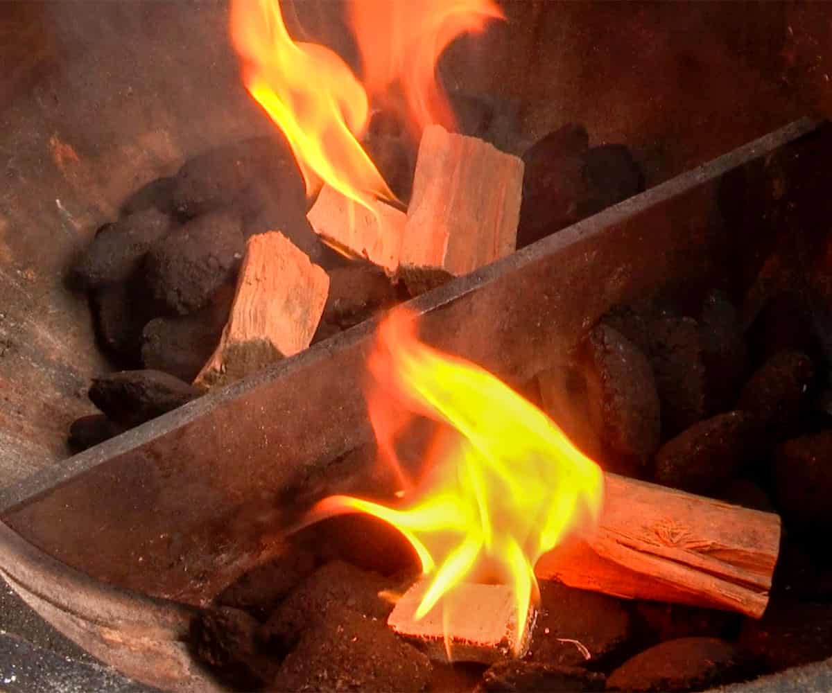 wood chunks catching fire in grill.