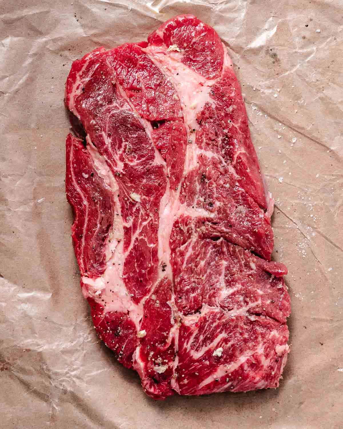 Two pound chuck steak on brown butcher paper.