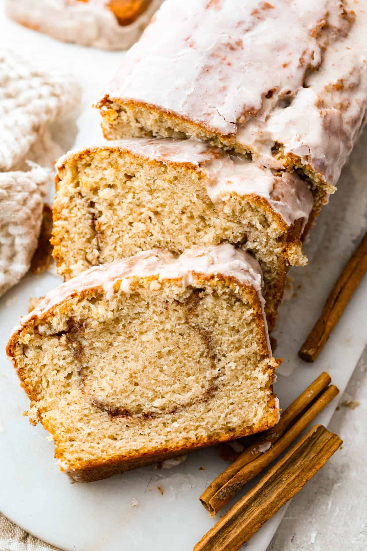 Snickerdoodle donut loaf with a couple of slices taken out of it. 