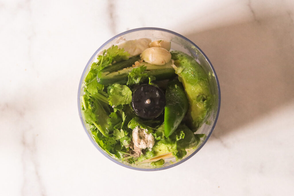 The ingredients in a food processor before blending.