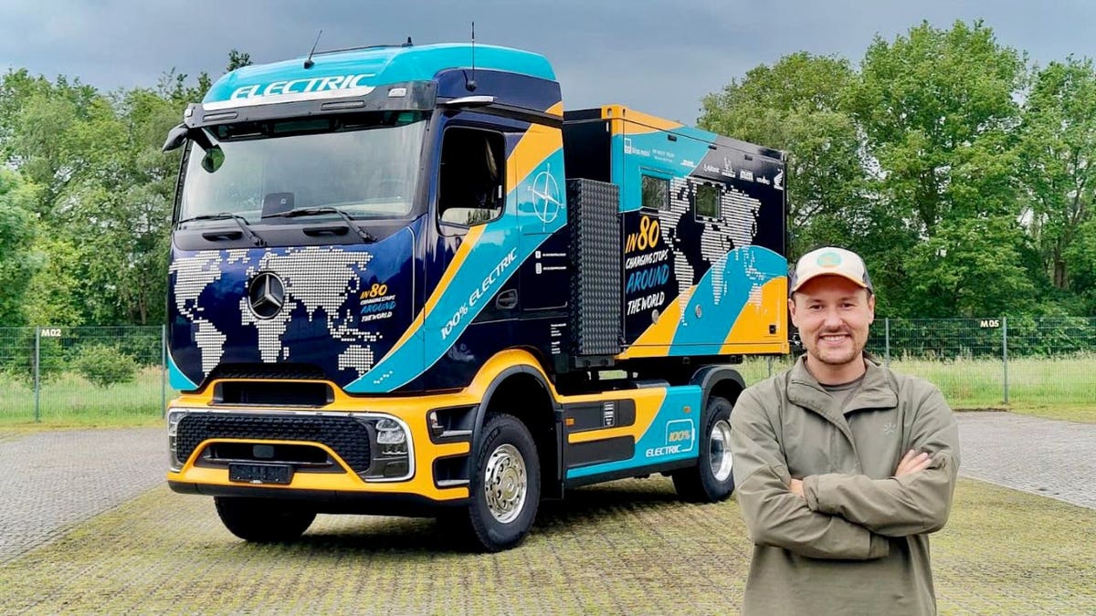 Tobias Wagner standing in front of a custom electric Mercedes-Benz eActros 600 motorhome.