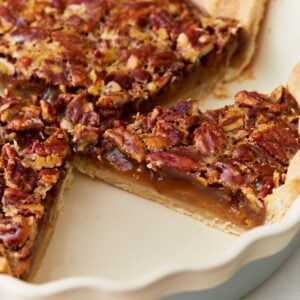 Side view of gluten-free pecan pie in a pie dish.