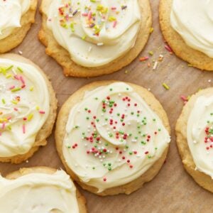 Close up overhead view of gluten-free sugar cookies topped with frosting and sprinkles.