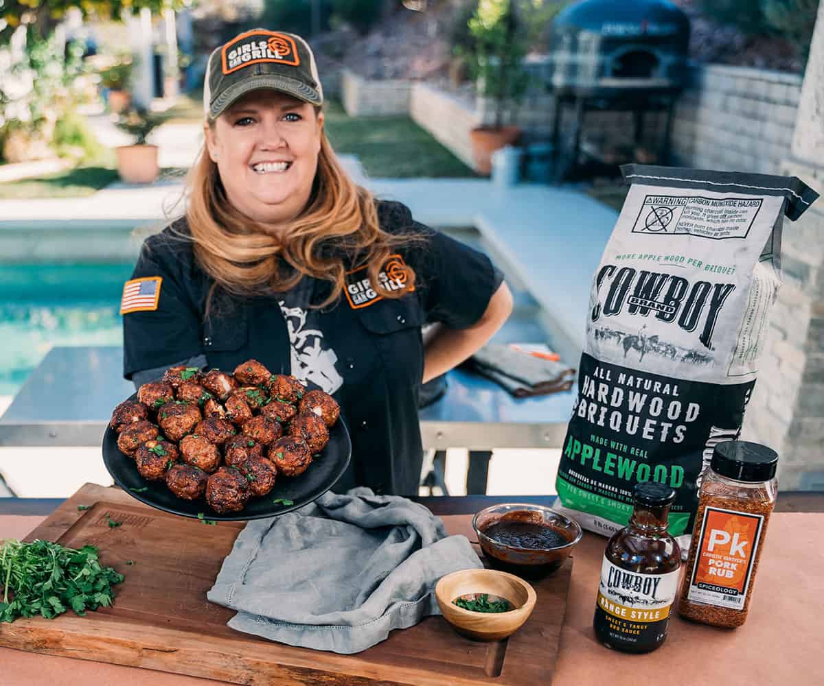 woman holding a platter of meatballs.
