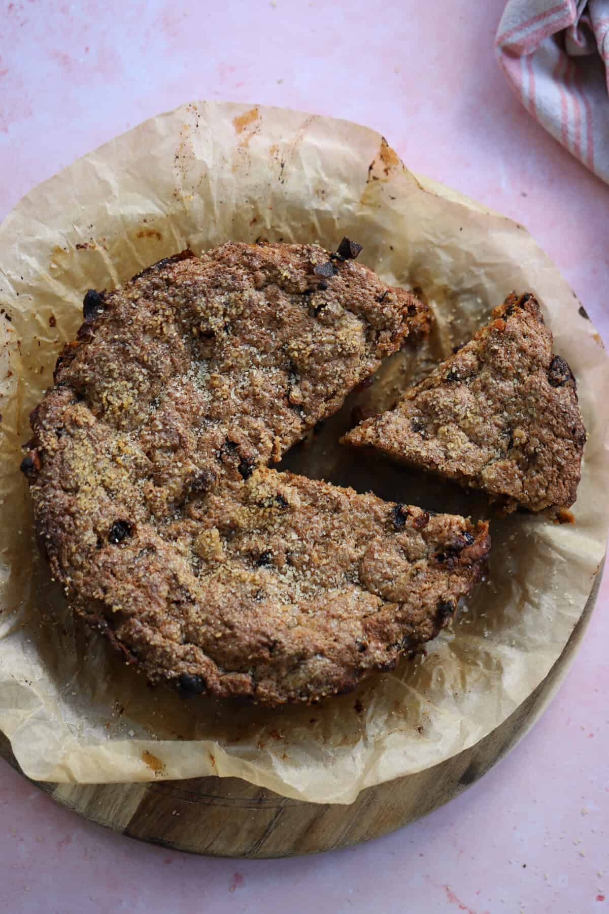A whole gluten free bread pudding with a slice cut from it.