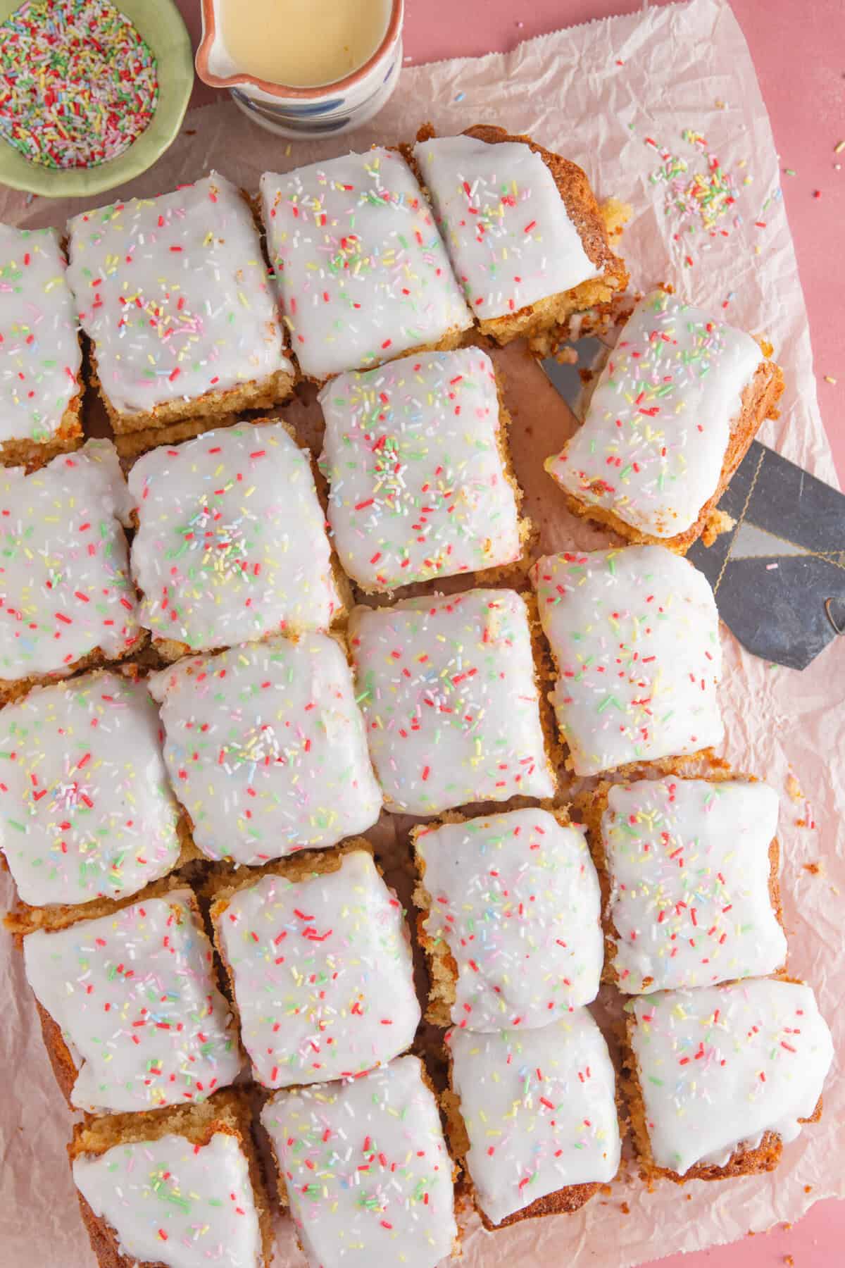 Process shot for gluten free school dinner cake showing the finished cake cut into squares.