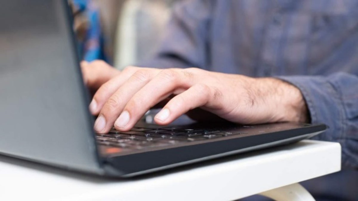 Typing at laptop