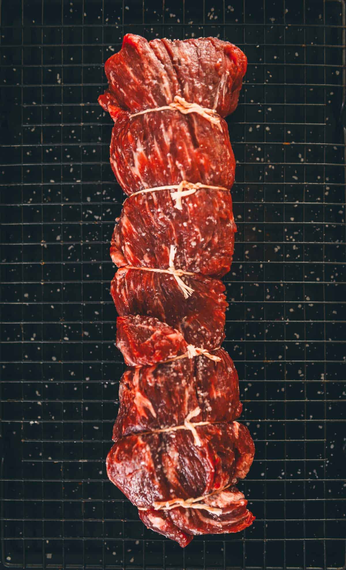 Salted tenderloin roast thats been air drying, showing a deeper richer red color.