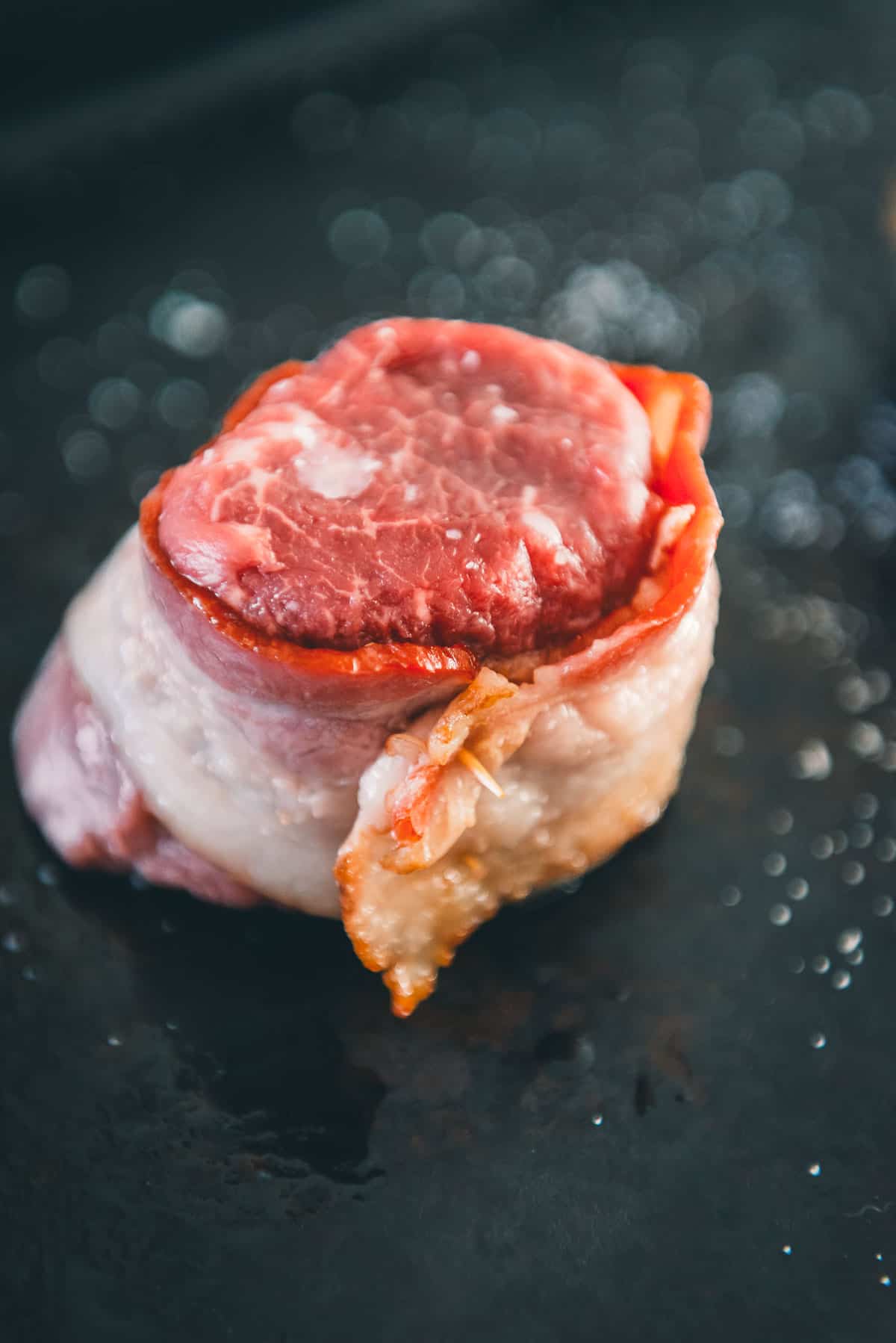 Filet wrapped in a slice of bacon.