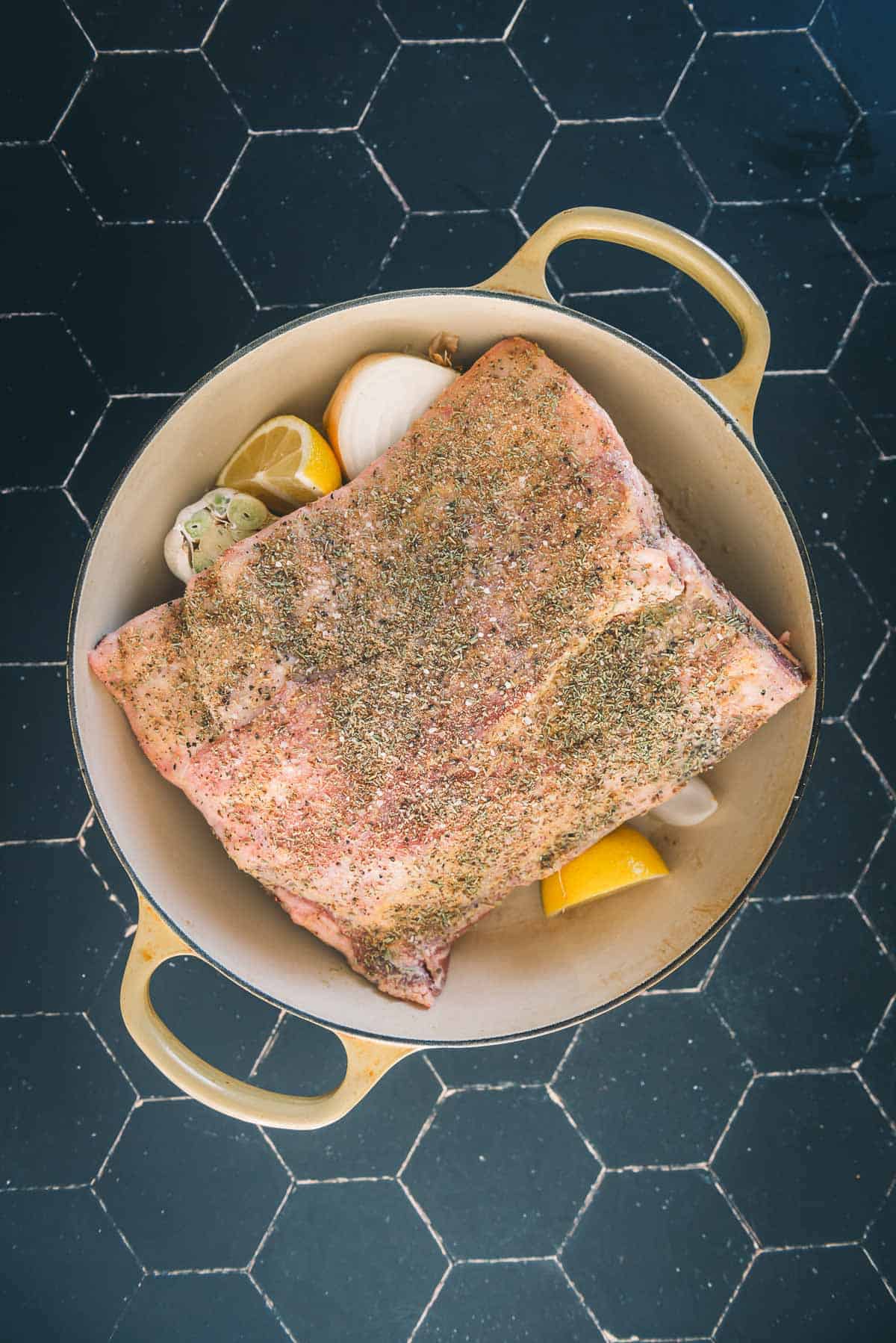 The lamb nestled into a baking dish with veggies underneath.