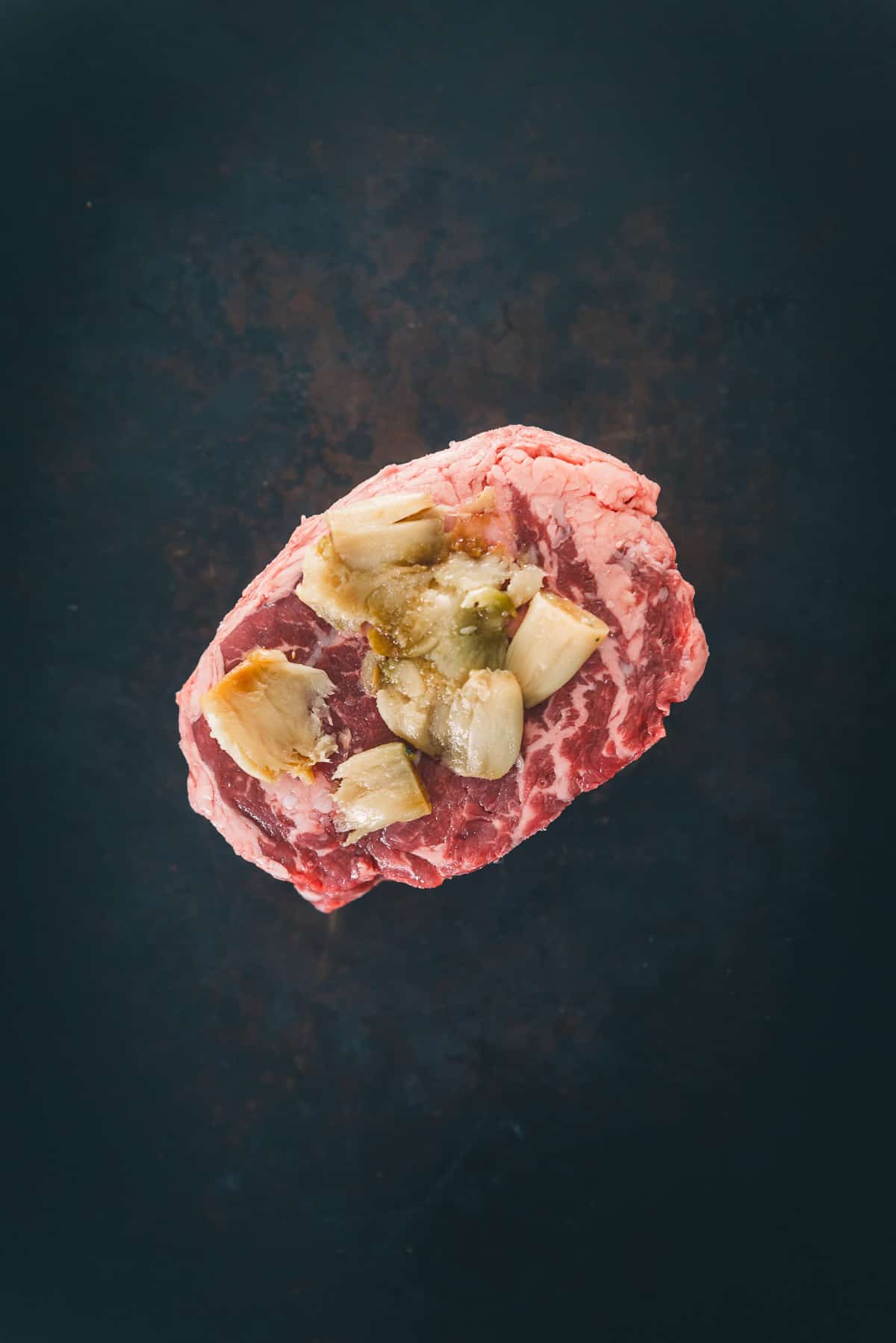 Chuck steak with garlic confit smashed on top.