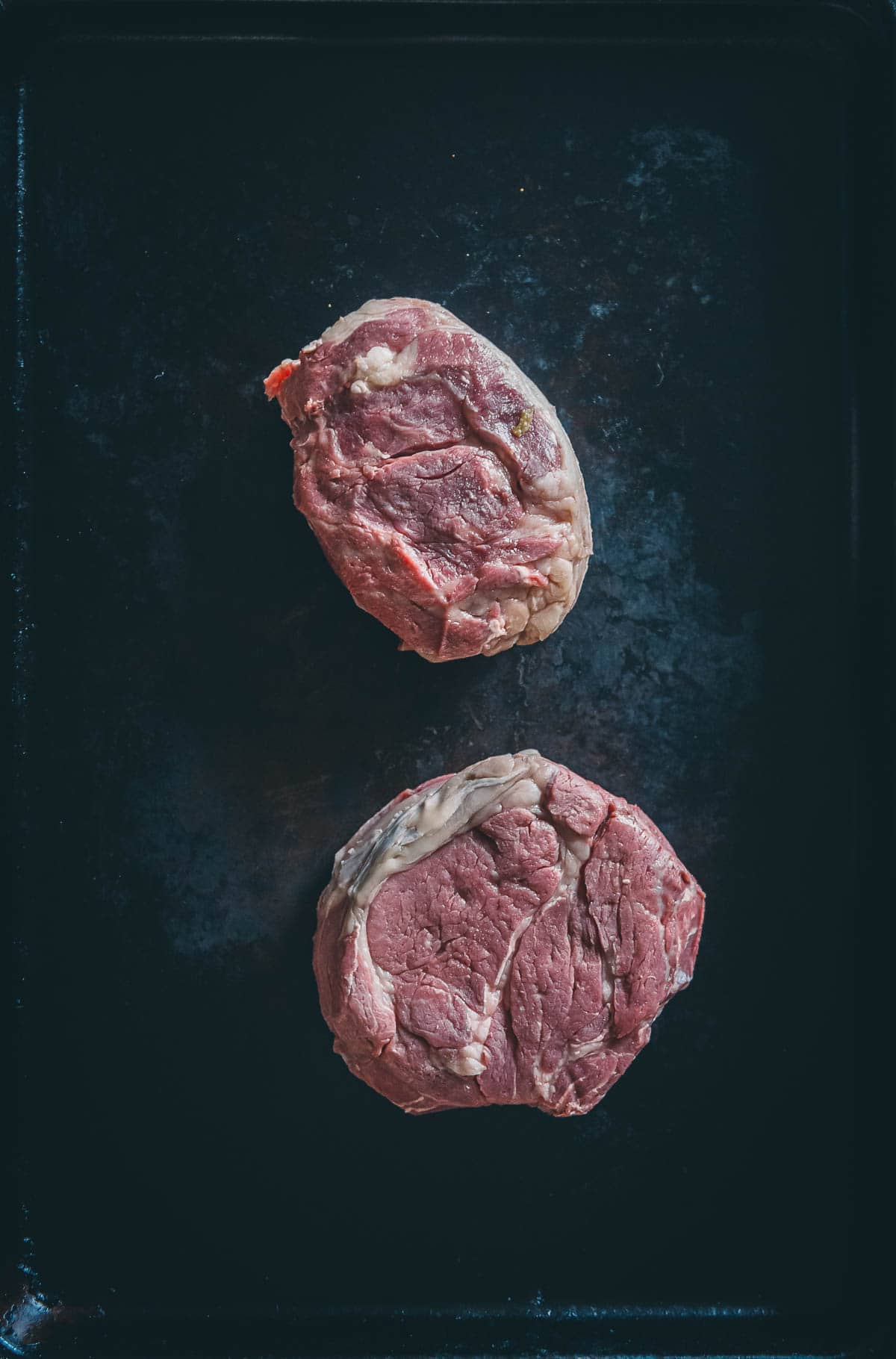 Showing the light brown color of chuck steaks removed from a sous vide bath.