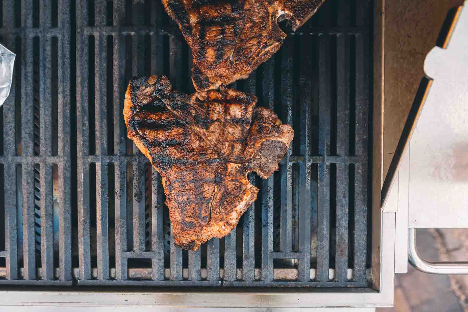 Overhead shot of steaks on the grill. 