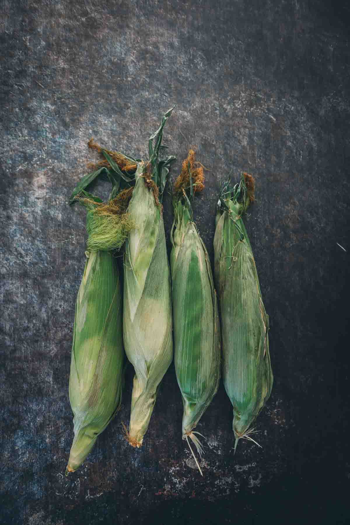 Fresh corn on a board.