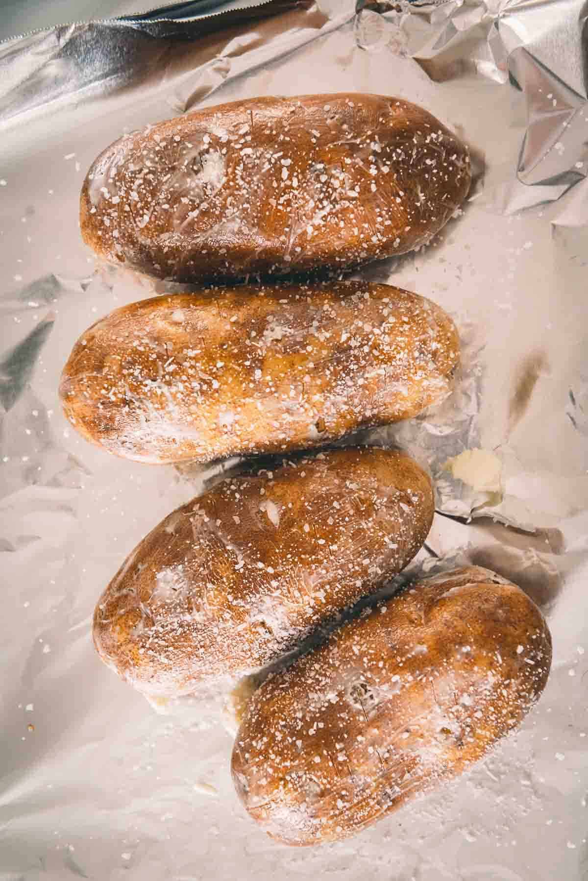 Potatoes rubbed with butter and coarse salt. 
