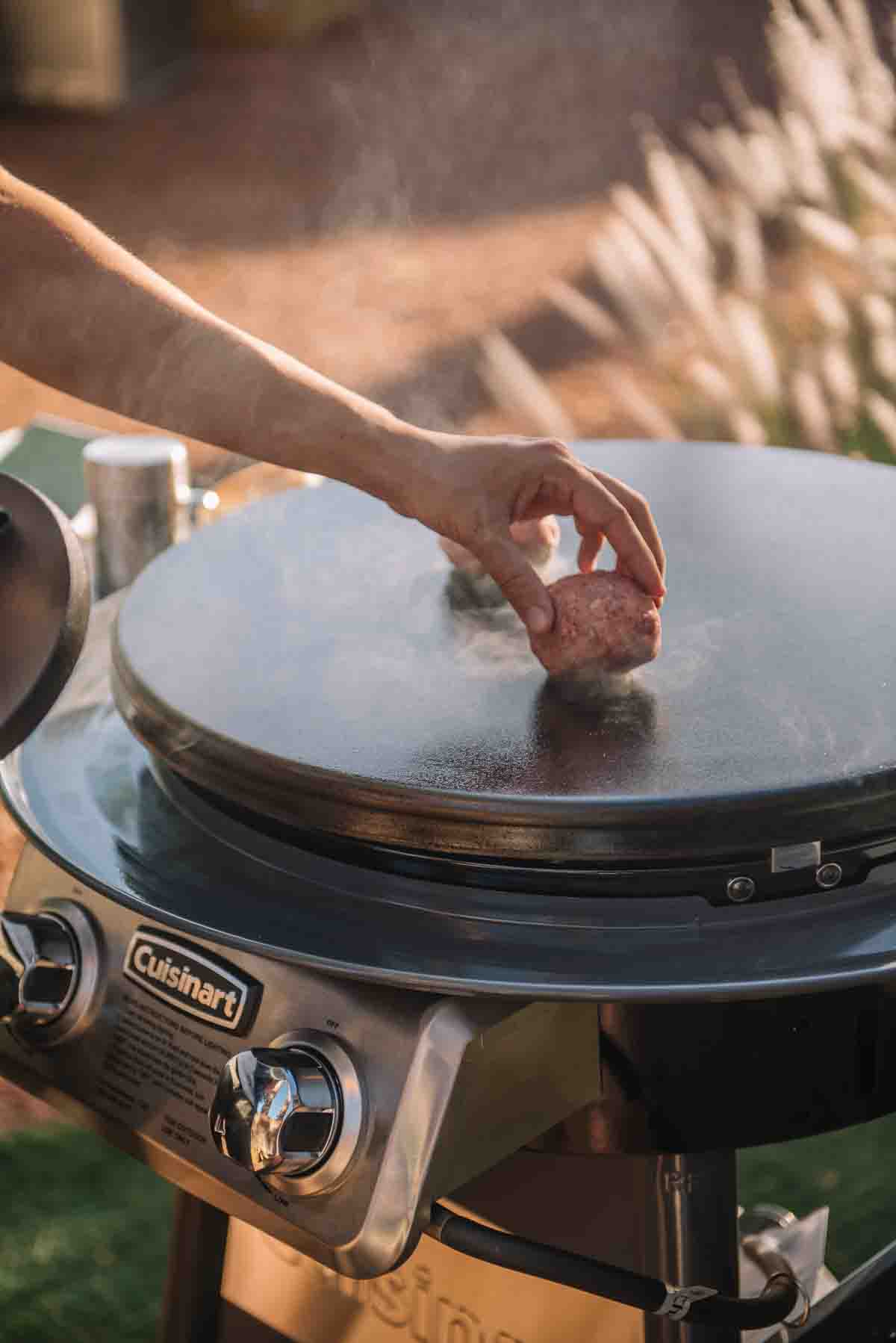 Placing the meat on the griddle.