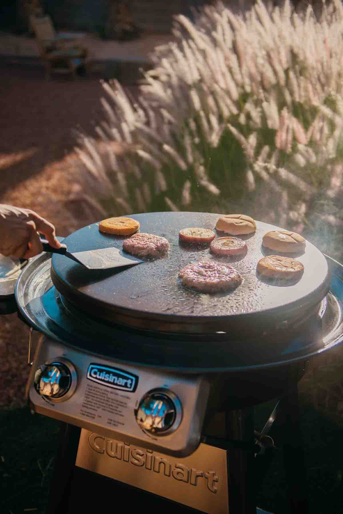 Flipping the burgers.