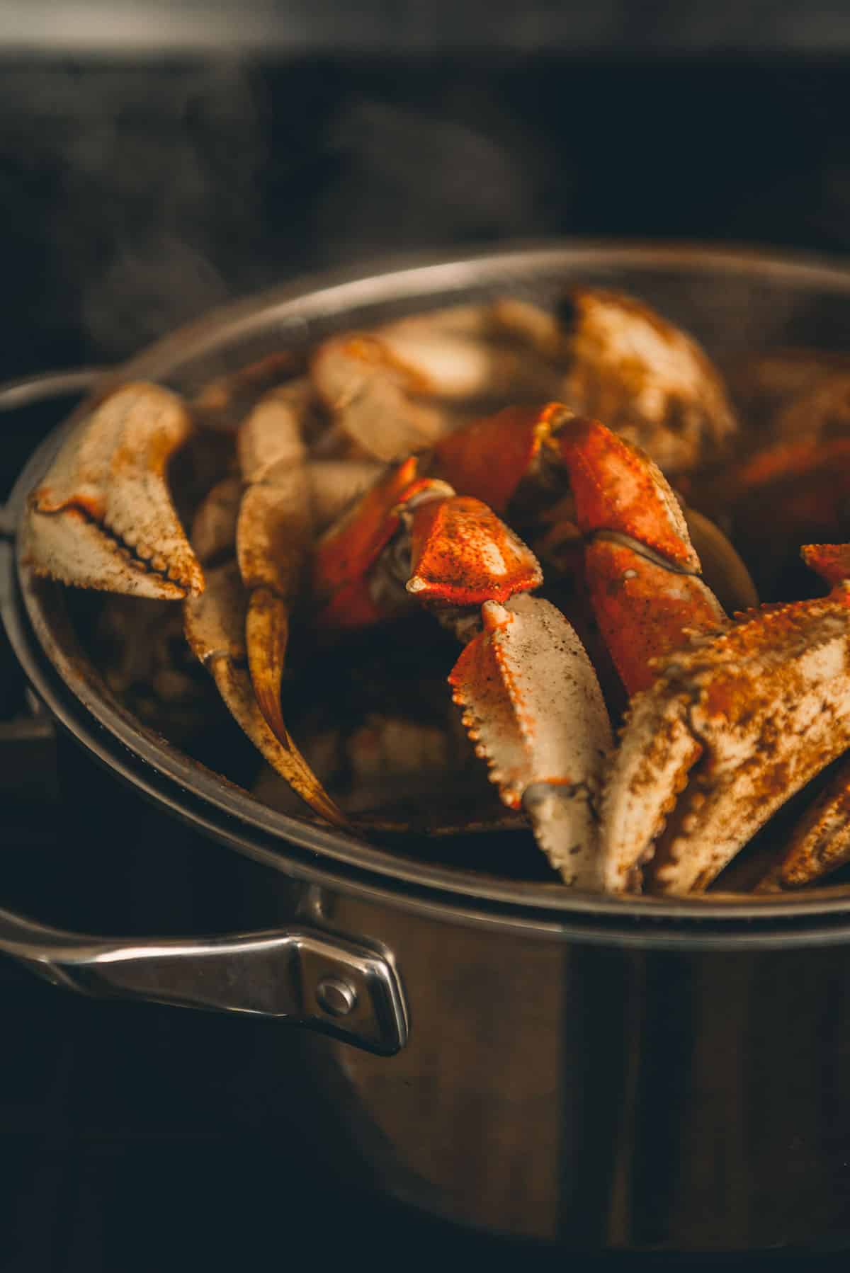 Close up of crab legs steaming. 
