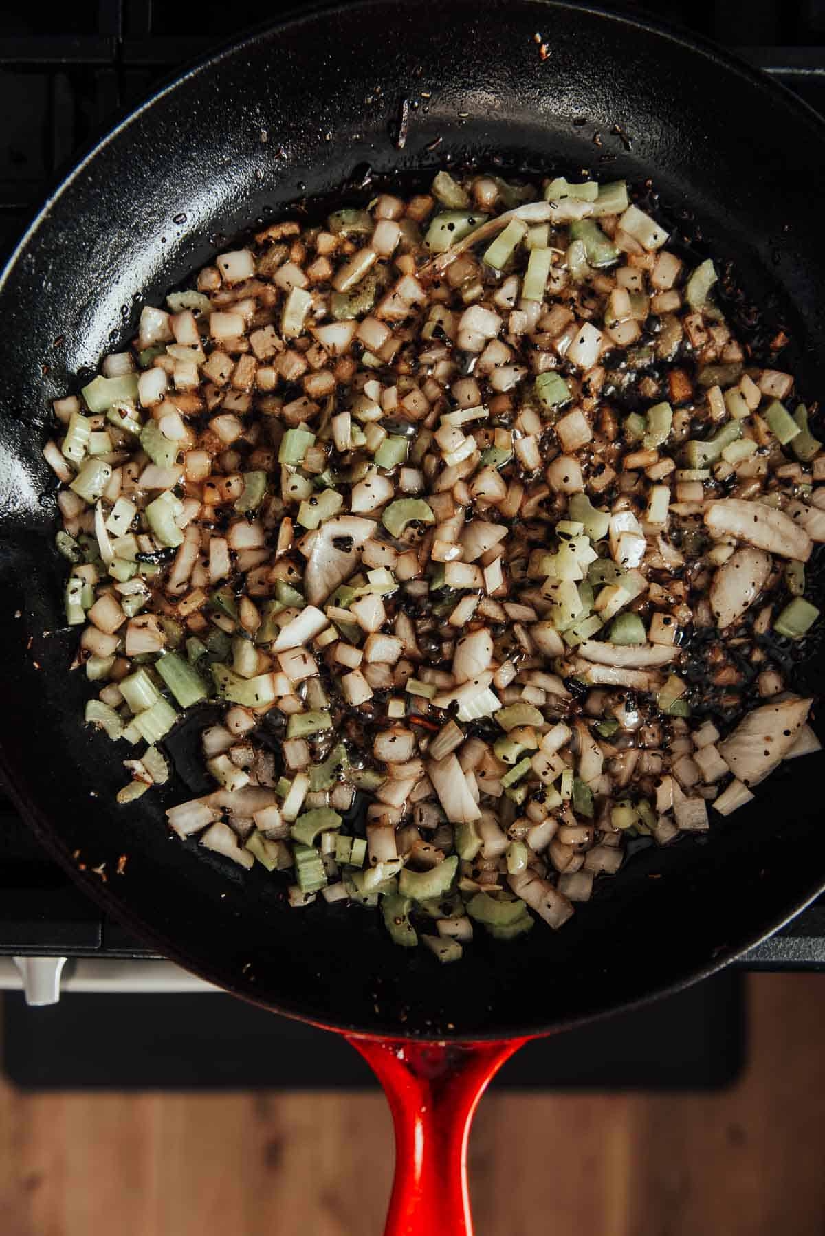 A skillet full of celery and onions.