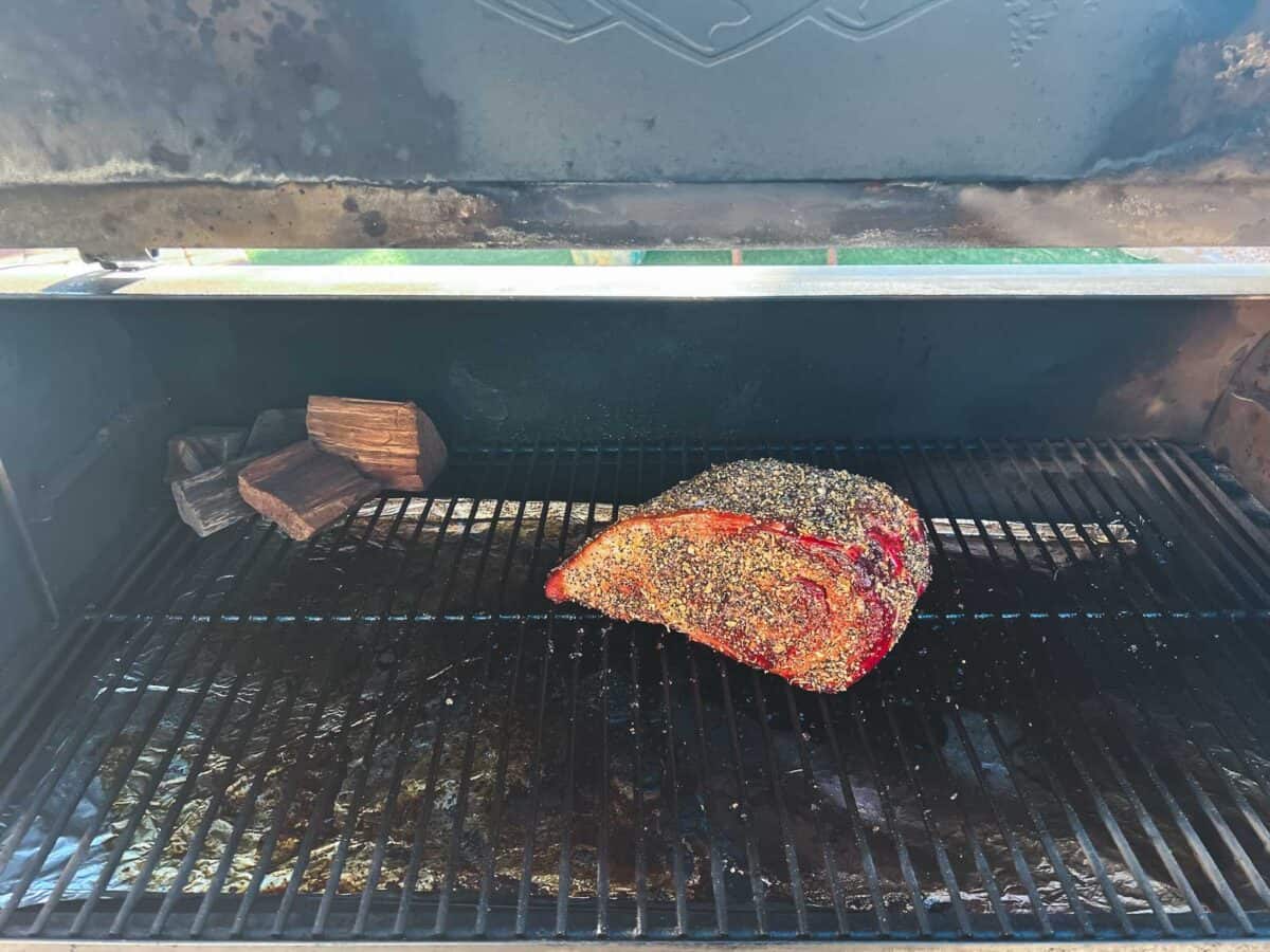 Prime rib slow roasting on a grill.