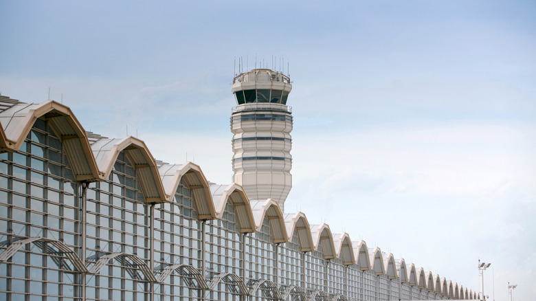 The Ronald Regan Washington National Airport air control tower looms over the airport terminal.