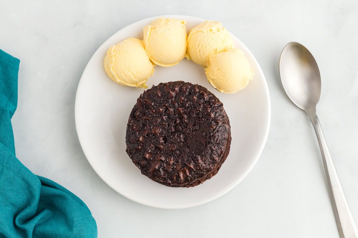 finished flourless mug cake served on a plate with vanilla ice cream