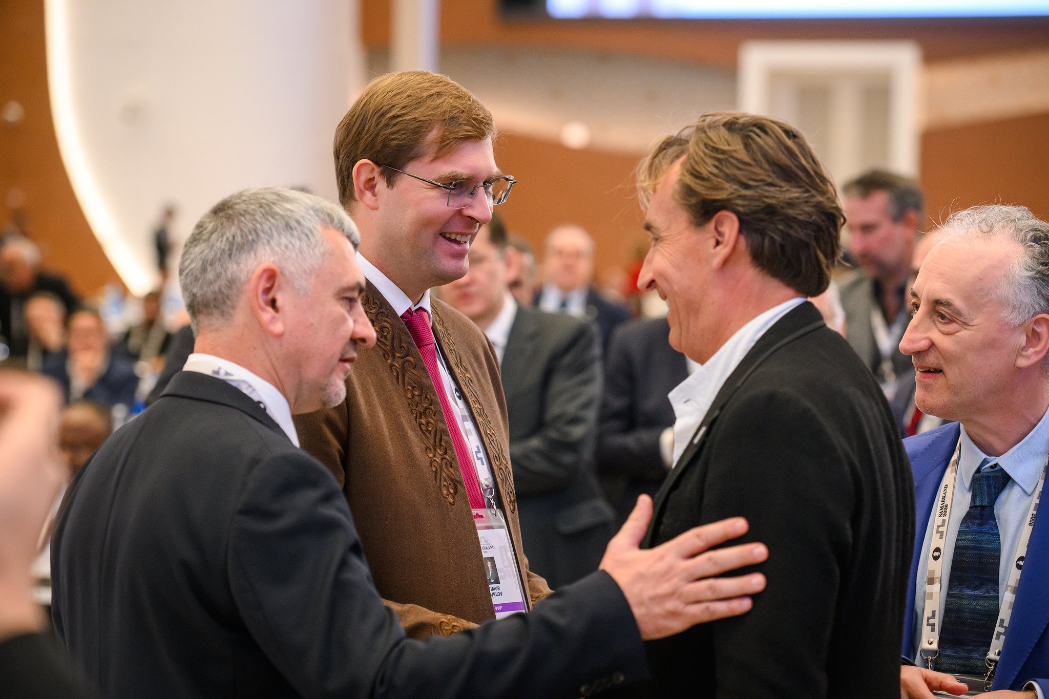 Timur Turlov is congratulated by Jan Henric Buettner and his running mate Malcolm Pein. Photo: Michal Walusza/FIDE.