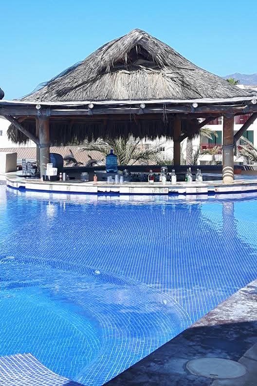 relax at the pool bar at a San Jose del Cabo resort and make new friends