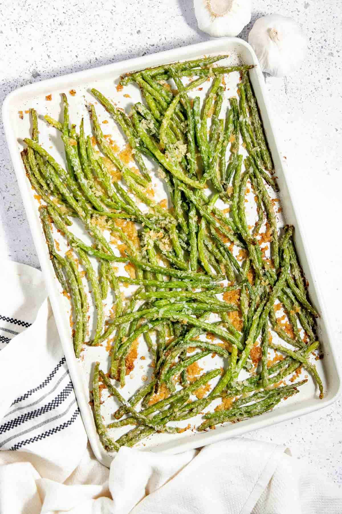Roasted green beans on a baking sheet.