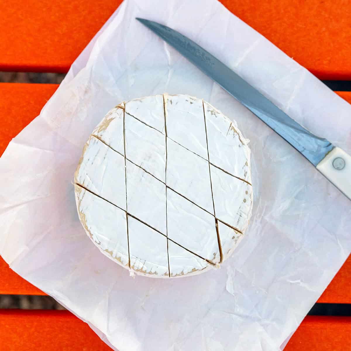 Brie wheel scored with diamonds.