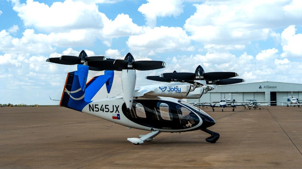 An air taxi sits at an airport.