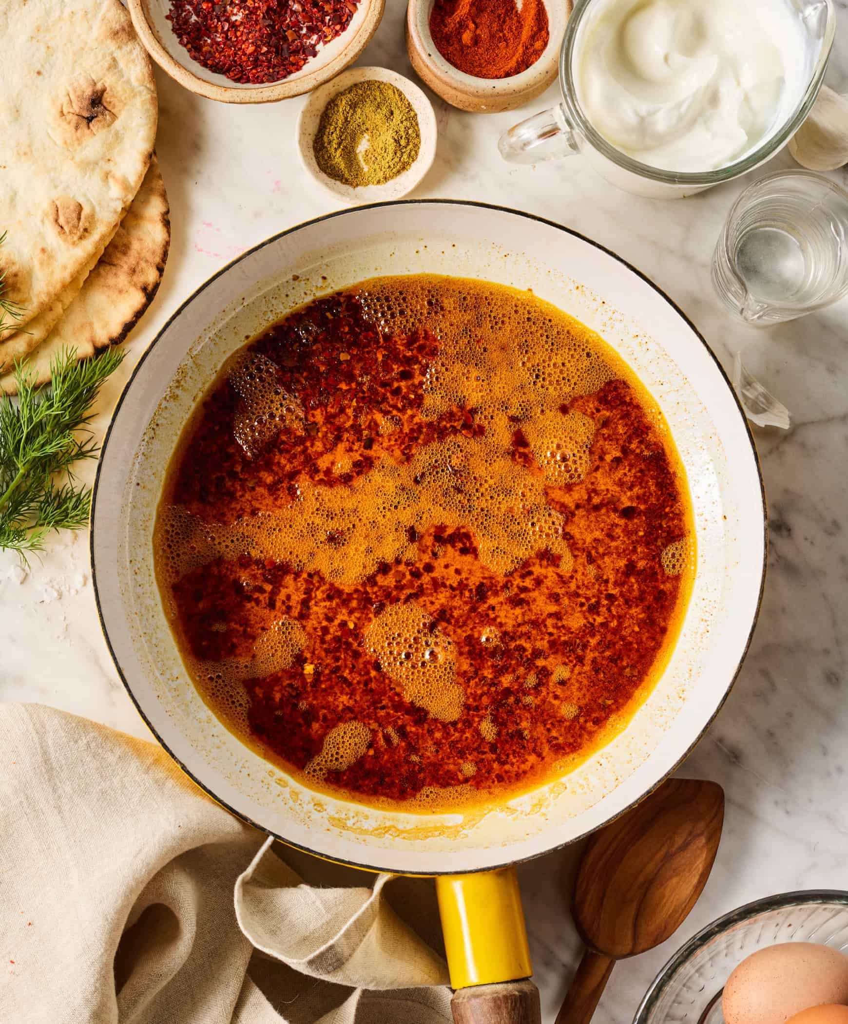 Simmering Aleppo pepper sauce in small skillet