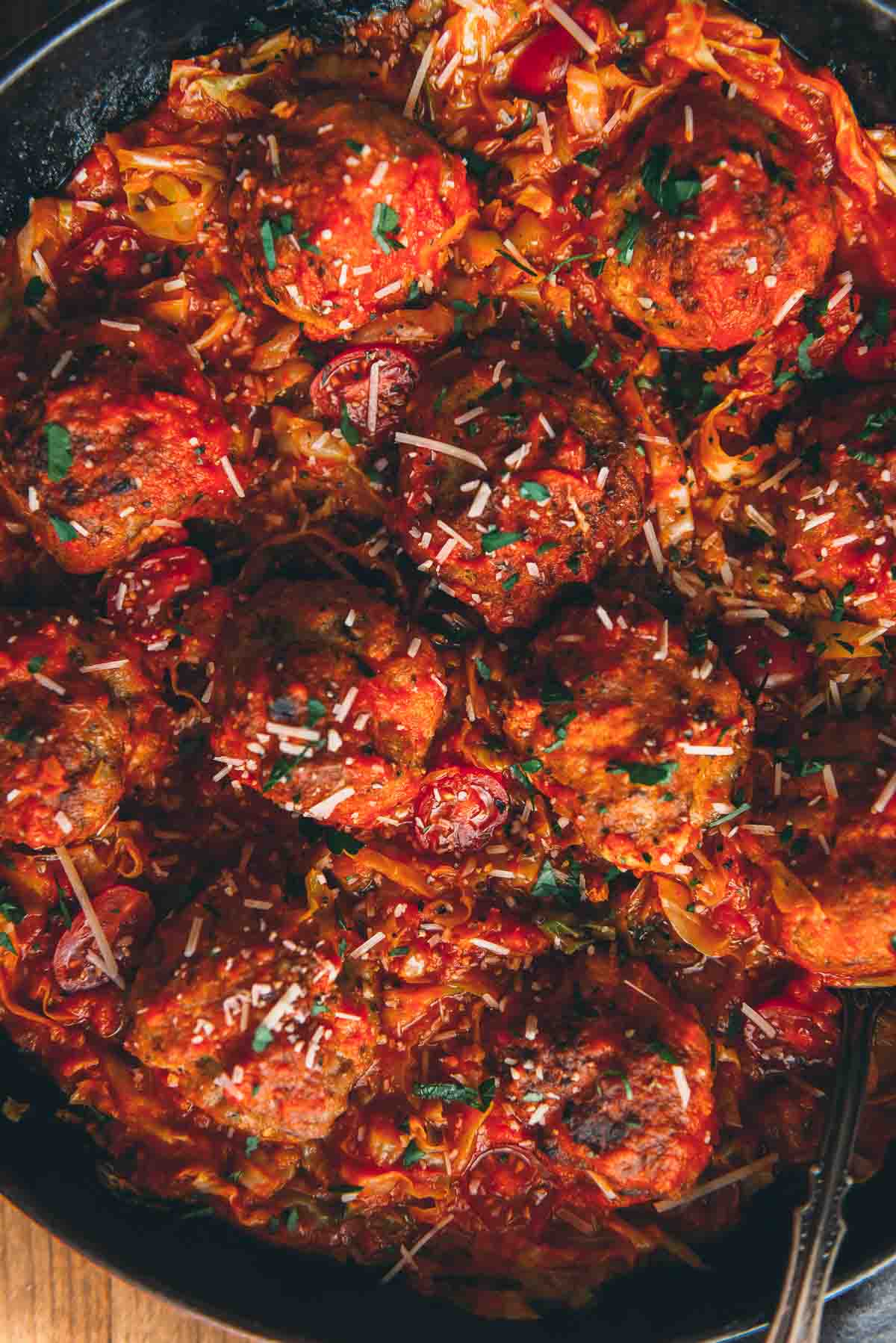 Vibrant shot of skillet filled with homemade italian meatballs.