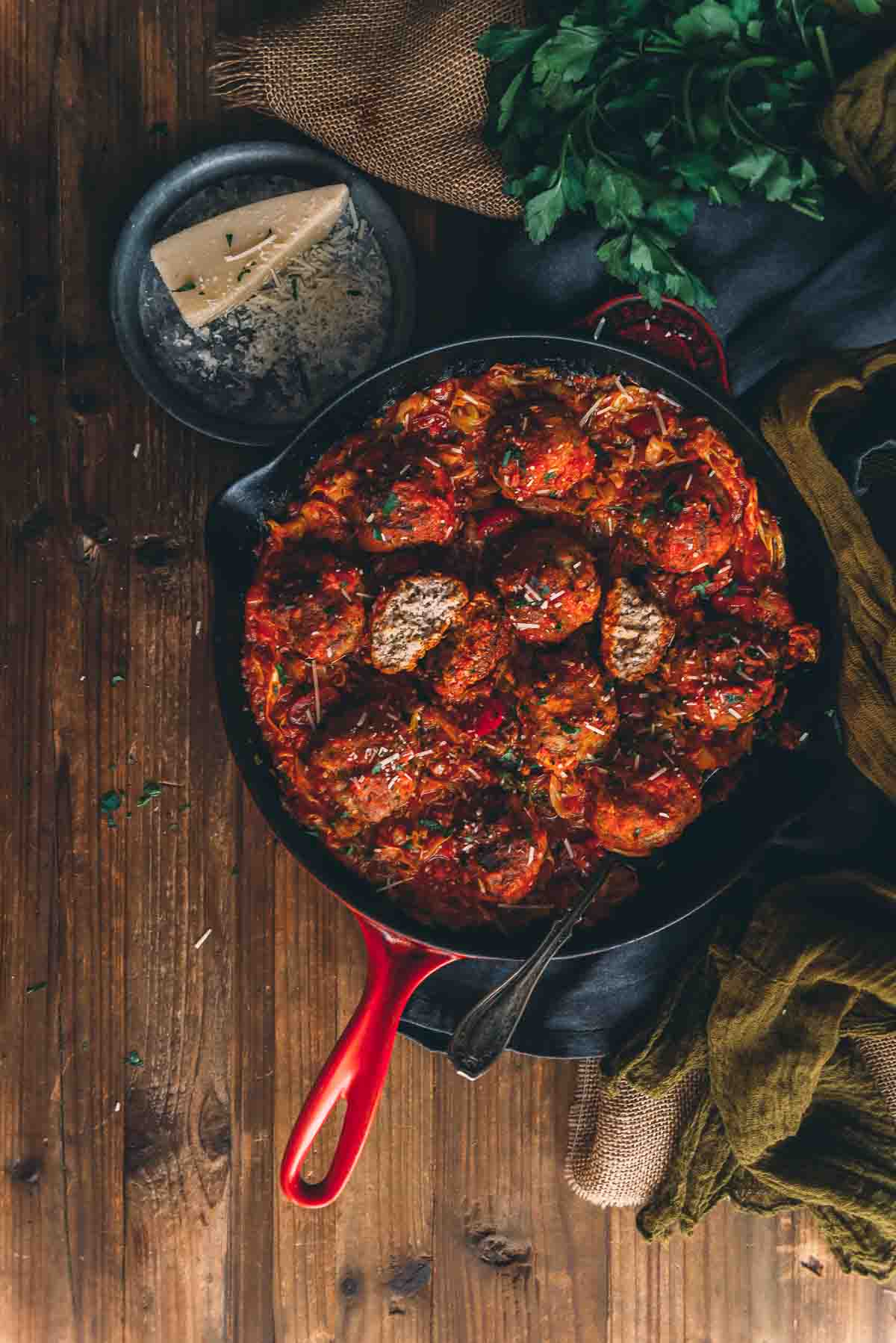 Overhead shot of skillet filled with savory veal meatballs.