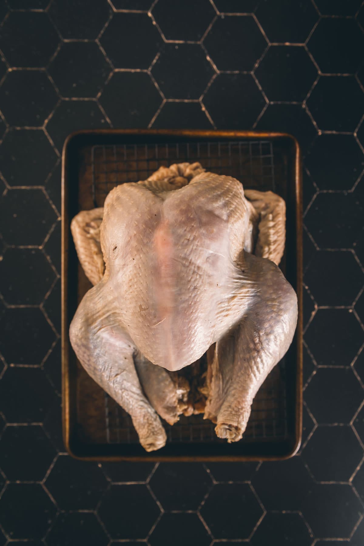 Raw turkey on a black board. 