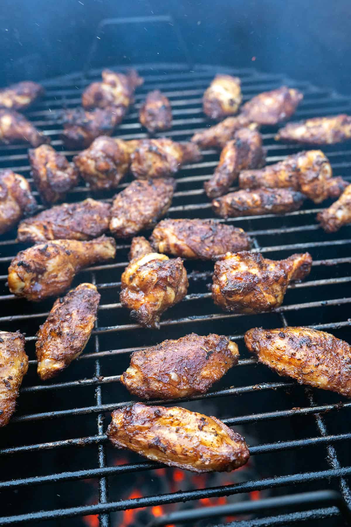 Seasoned wings on drum smoker after 20 minutes.