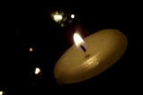 A candle and Christmas lights