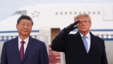 Trump winces during military flyover at Xi arrival ceremony