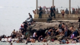 Hundreds of migrants swim from Morocco to Spanish enclave of Ceuta