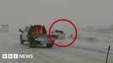Car nearly hits first responders in Midwest blizzard conditions