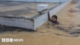 Scores killed and thousands evacuated from record rainfall